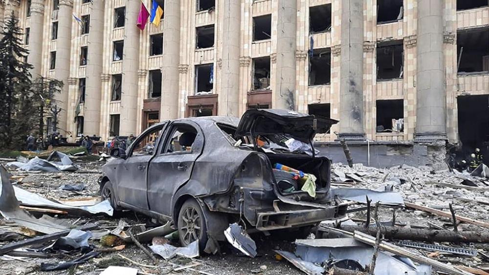 In this handout photo released by Ukrainian Emergency Service, a burnt car is seen in front of a damaged City Hall building, in Kharkiv, Ukraine, Tuesday, March 1, 2022. (Ukrainian Emergency Service via AP)