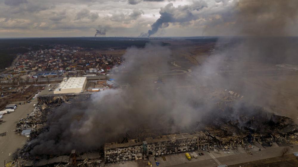 A factory and a store burn after having been bombarded in Irpin, in the outskirts of Kyiv, Ukraine, Sunday, March 6, 2022. (AP Photo/Emilio Morenatti)