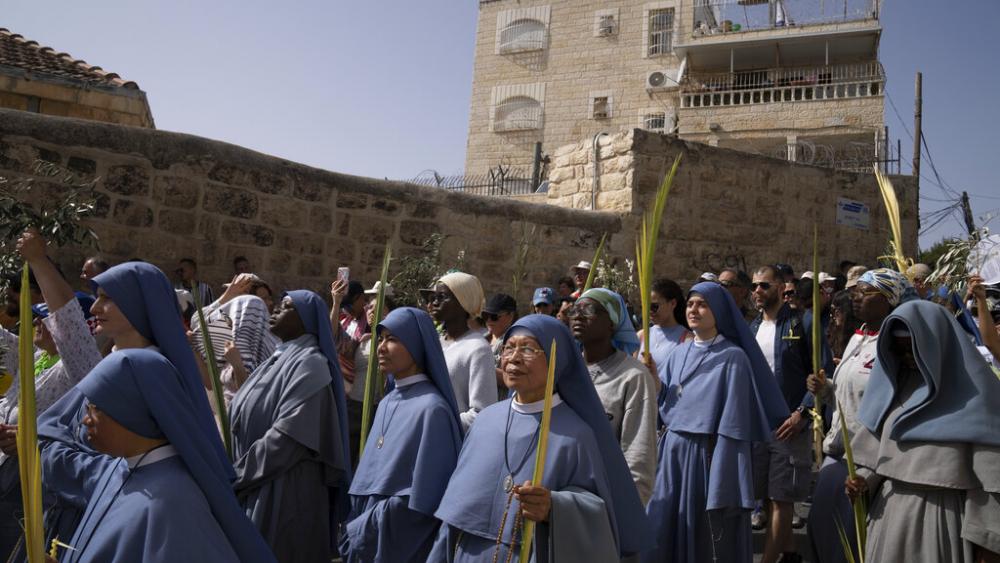 Nuns walk in the Palm Sunday procession on the Mount of Olives in Jerusalem, Sunday, April 10, 2022. (AP Photo/Maya Alleruzzo)