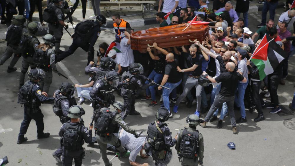 Israeli police confront with mourners as they carry the casket of slain Al Jazeera veteran journalist Shireen Abu Akleh during her funeral in Jerusalem, Friday, May 13, 2022. (AP Photo)