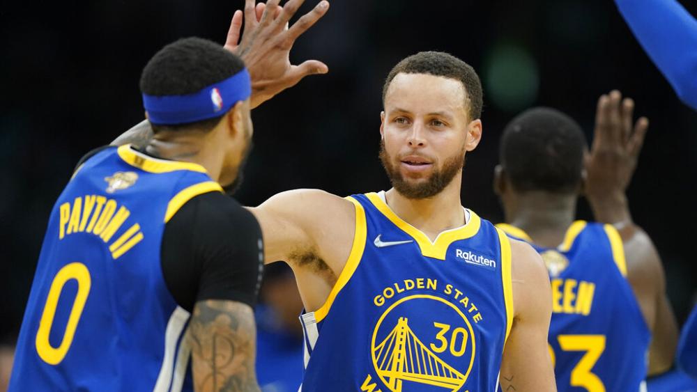 Golden State Warriors guard Stephen Curry (30) high fives Golden State Warriors guard Gary Payton II (0) during the second quarter of Game 6 of basketball&#039;s NBA Finals against the Boston Celtics, Thursday, June 16, 2022, in Boston. (AP Photo/Steven Senne)