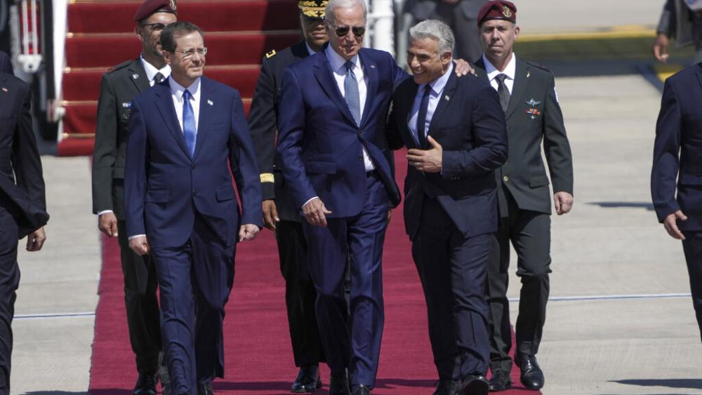 President Joe Biden, center, welcome by Israeli Prime Minister Yair Lapid, right, and Israeli President Isaac Herzog during a welcoming ceremony at Ben Gurion airport near Tel Aviv, Israel, Wednesday, July 13, 2022.  (AP Photo/Evan Vucci)
