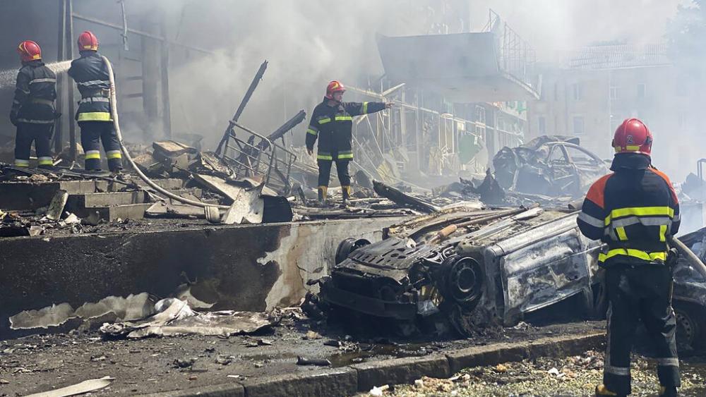 In this photo provided by the Ukrainian Emergency Service, firefighters work to extinguish fire at a building damaged by shelling, in Vinnytsia, Ukraine, Thursday, July 14, 2022. (Ukrainian Emergency Service via AP)