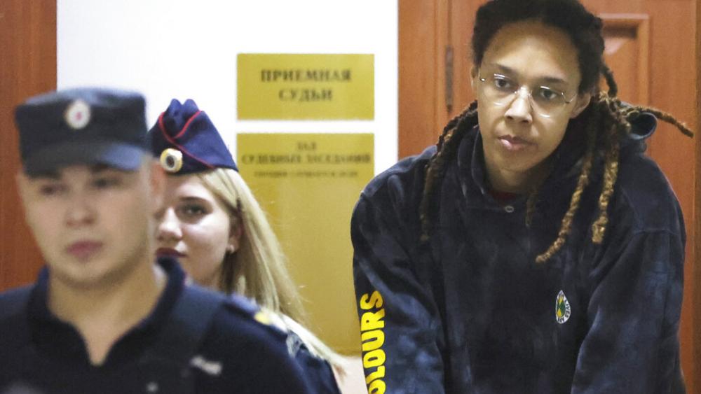 WNBA star and two-time Olympic gold medalist Brittney Griner is escorted to a courtroom for a hearing, in Khimki just outside Moscow, Russia, Monday, July 25, 2022. (Evgenia Novozhenina/Pool Photo via AP)