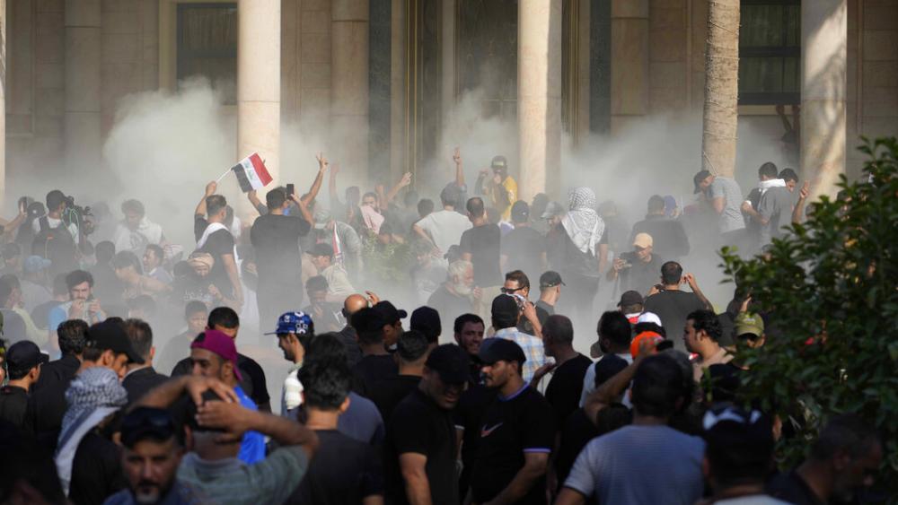 Iraqi security forces fire tear gas on the followers of Shiite cleric Muqtada al-Sadr inside the government Palace, Baghdad, Iraq, Monday, Aug. 29, 2022.  (AP Photo)