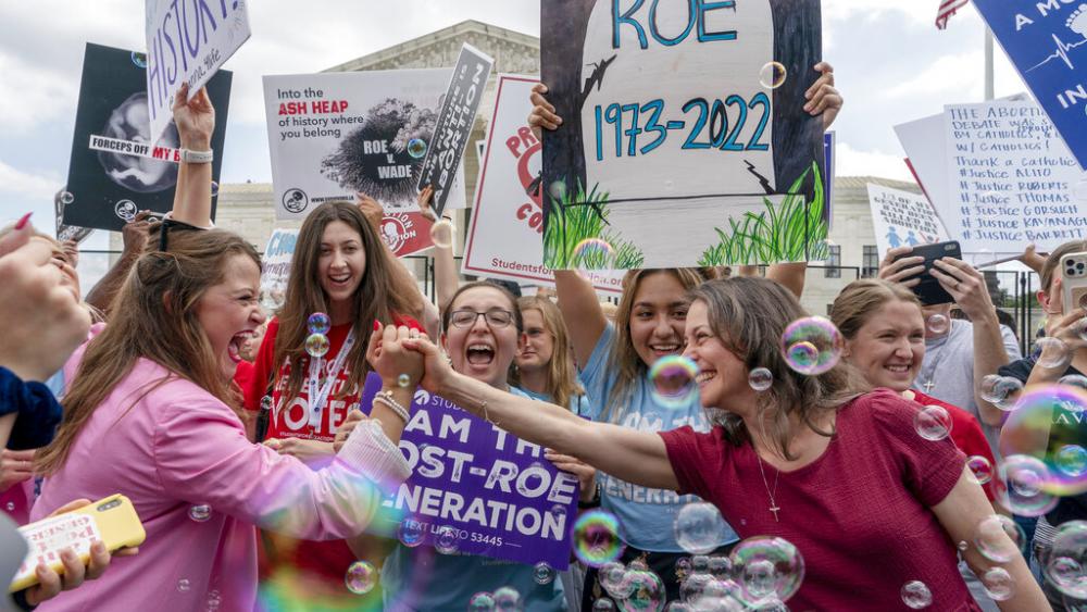 Pro-lifers celebrate the Supreme Court's decision to overturn Roe v. Wade, outside the Supreme Court in Washington, June 24, 2022. (AP Photo/Gemunu Amarasinghe)