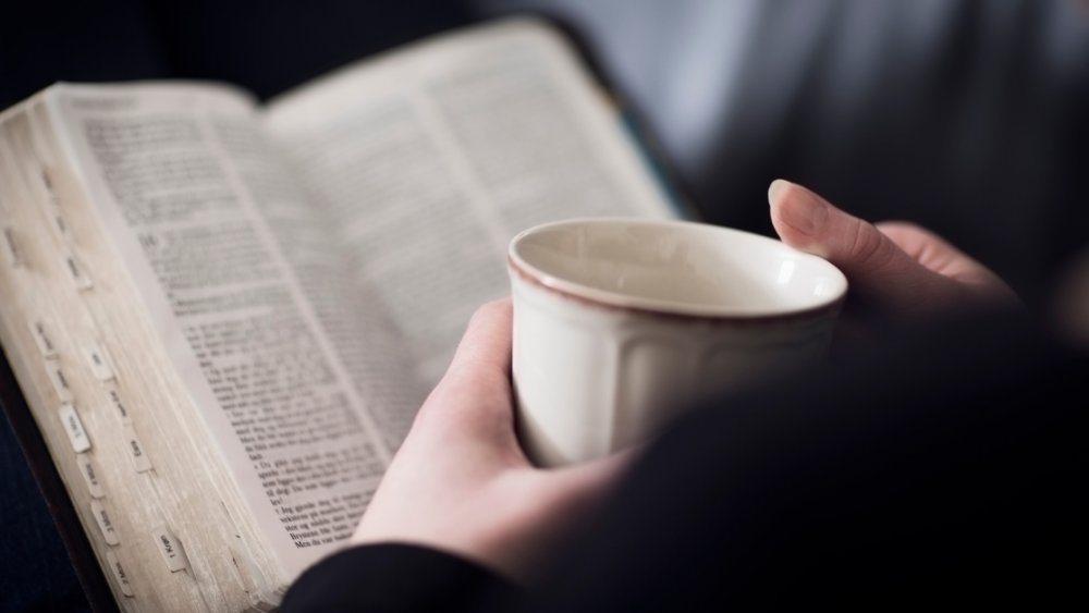 reading the Bible with a cup of coffee