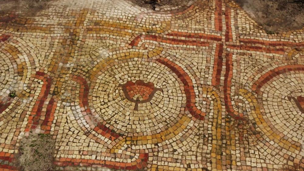 An ancient mosaic floor adorned with colorful floral designs has been re-uncovered after 40 years along the Israel National Trail. Photo Credit: Emil Aladjem, Israel Antiquities Authority.