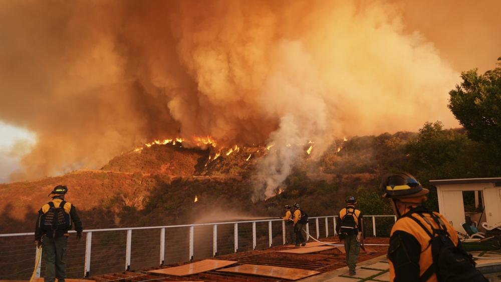 Fire crews monitor the Palisades Fire in Mandeville Canyon on Jan. 11, 2025, in Los Angeles. (AP Photo/Jae C. Hong)