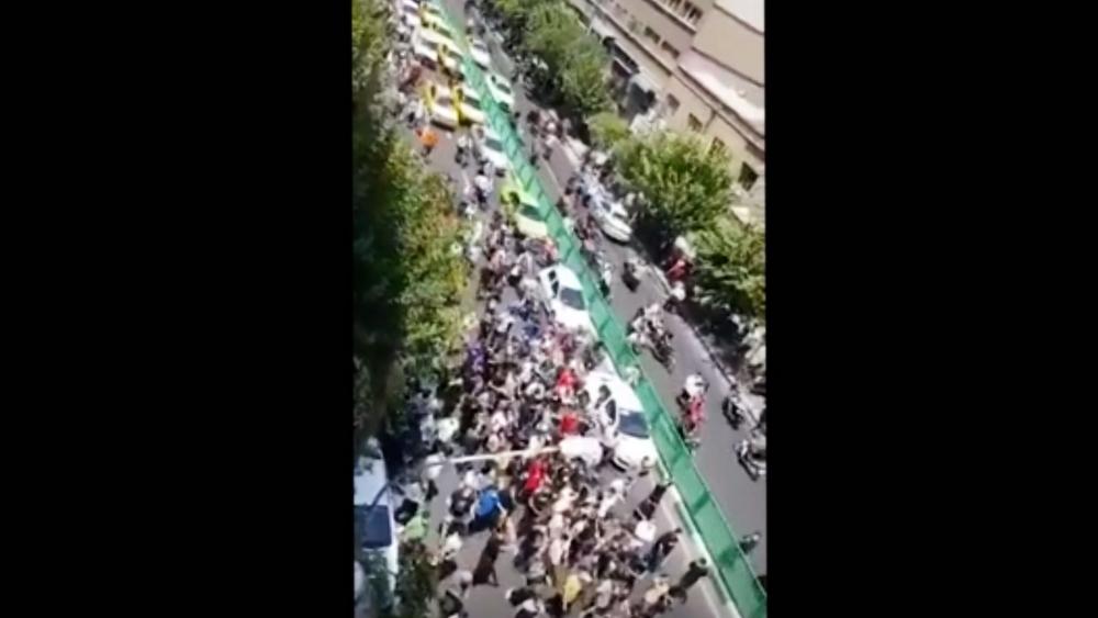 Dozens of demonstrators march down Jomhuri Islami Avenue amid protests over water shortages. (AP video)