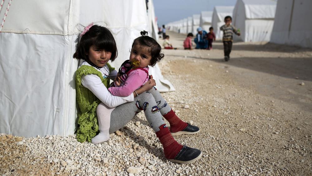 Syrian refugee children who fled violence in Syrian city of Ain al-Arab, known also as Kobani, seen outside their tents in a camp in the border town of Suruc, Turkey, in 2015. (AP Photo)