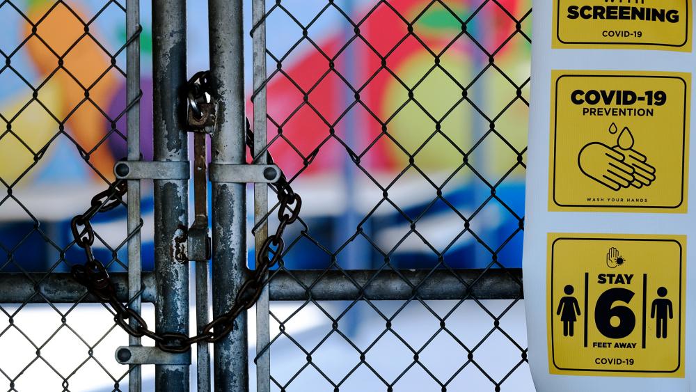 A chain-link fence lock is seen on a gate at a closed Ranchito Elementary School in the San Fernando Valley section of Los Angeles on July 13, 2020 (AP Photo/Richard Vogel)