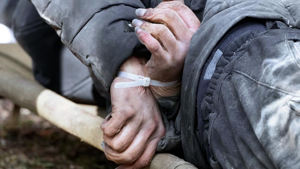 A dead civilian with his hands tied behind his back lies on the ground in Bucha close to Kyiv, Ukraine, April 4, 2022. (AP Photo/Efrem Lukatsky)