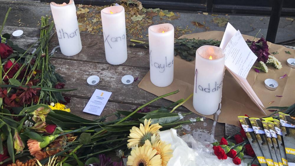 Candles and flowers at a make-shift memorial honoring four slain University of Idaho students in downtown Moscow, Idaho, on Nov. 15, 2022. (AP Photo/Nicholas K. Geranios)
