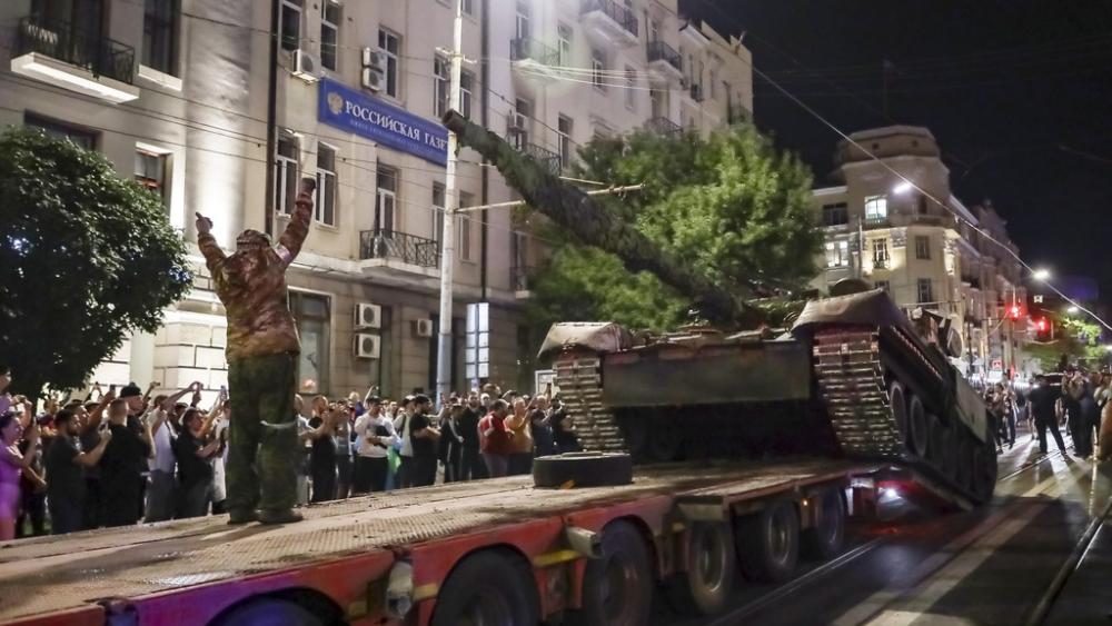 Members of the Wagner Group military company load their tank onto a truck on a street in Rostov-on-Don, Russia, Saturday, June 24, 2023, prior to leaving an area at the headquarters of the Southern Military District. (AP Photo)