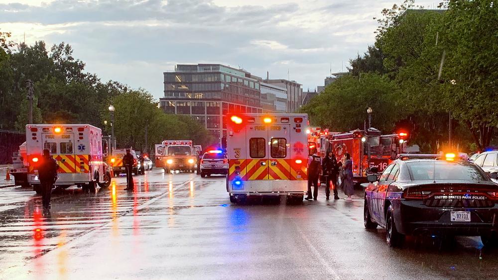 Emergency medical crews respond on Pennsylvania Ave. between the White House and Lafayette Park, after lighting struck four people on Aug. 4, 2022. (@dcfireems via AP)