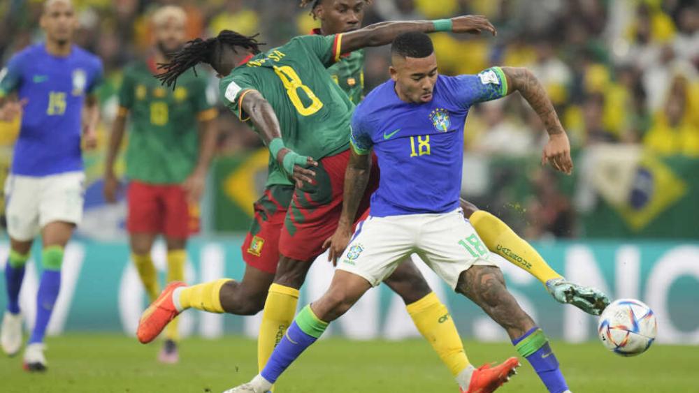 Brazil&#039;s Gabriel Jesus and Cameroon&#039;s Andre-Frank Zambo Anguissa fight for the ball during the World Cup group G soccer match between Cameroon and Brazil, at the Lusail Stadium in Qatar, Dec. 2, 2022. (AP Photo/Moises Castillo)